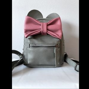 Grey backpack with ears and pink bow